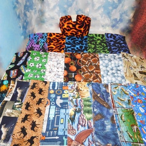 May include: A collection of fabric squares with various patterns, including sports themes, animals, and nature scenes. The fabrics are arranged in rows and columns, creating a colorful and visually appealing display.