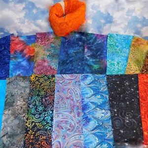 May include: A collection of 15 fabric squares in various colors and patterns, including blue, teal, red, orange, and brown. The fabric squares are arranged in a grid pattern.