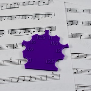 May include: Purple plastic tool with a star shape and measurements from 9 to 12.5 inches.