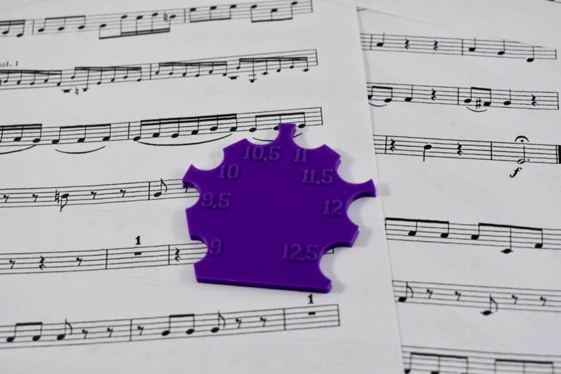 May include: Purple plastic tool with a star shape and measurements from 9 to 12.5 inches.
