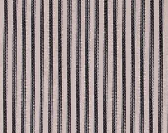May include: White fabric with thin black stripes. The fabric is measured with a ruler in inches.