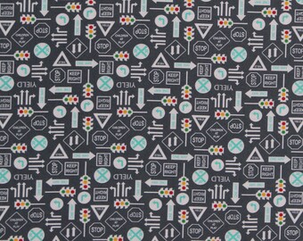 May include: A black and white fabric with a repeating pattern of traffic signs and symbols. The signs include "Yield", "Stop", "Keep Right", "One Way", and "Children at Play". There are also traffic lights, arrows, and other road markings.