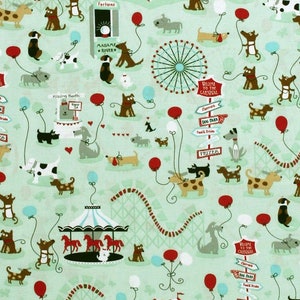 May include: A light green fabric featuring a whimsical carnival scene with cartoon dogs, roller coasters, Ferris wheels, and tents. Red, blue, and white balloons float throughout the design. The fabric includes signs that say "Welcome to the Carnival".