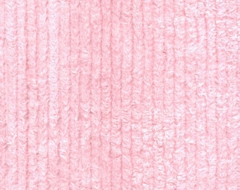 May include: Close-up of a light pink, textured fabric with vertical ribbing. A U.S. quarter coin is in the upper right corner for scale. The fabric appears soft and plush, possibly a towel or blanket.
