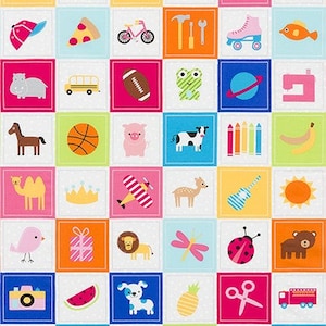 May include: A colorful patchwork fabric featuring a grid of squares, each with a different cartoon illustration. Images include a rocket, strawberry, apple, flamingo, pizza, bicycle, roller skate, and more. The fabric has a pink dotted border.