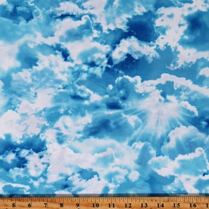 May include: A blue and white fabric with a cloud pattern. The fabric has a light blue background with white clouds.