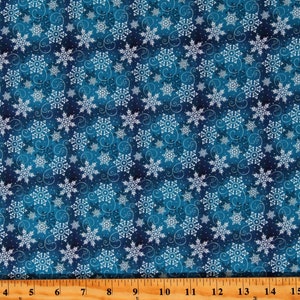 May include: A blue fabric with a white snowflake pattern. The snowflakes are scattered across the fabric and are surrounded by small white dots. The fabric has a subtle watercolor effect.