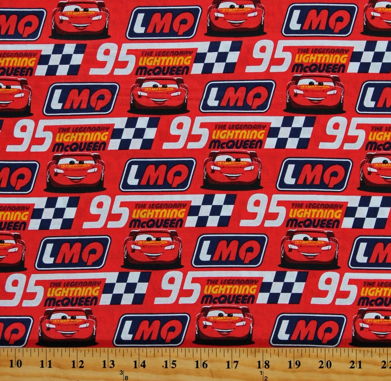 May include: Red fabric with a repeating pattern of a red race car with the number 95 and the words "The Legendary Lightning McQueen" and "LMQ".
