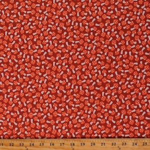 May include: Red fabric with a white mushroom pattern. The mushrooms are scattered randomly across the fabric.