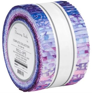 May include: A roll of fabric strips from the "Dancing Petals" collection, featuring a watercolor floral design in shades of purple, blue, and pink. Each strip measures 2.5 inches wide. The roll is secured with a white band.