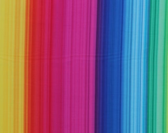 May include: A colorful fabric with vertical stripes in shades of yellow, orange, red, pink, purple, blue, green, and turquoise. The fabric is measured with a ruler in inches.