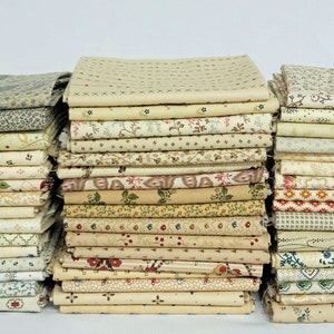 May include: A stack of 30 cream-colored fabric squares with various floral and geometric patterns. The fabric squares are arranged in three stacks of 10.