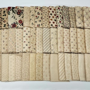 May include: A collection of 40 fabric squares in various beige and cream colors with different patterns, including floral, geometric, and polka dots.
