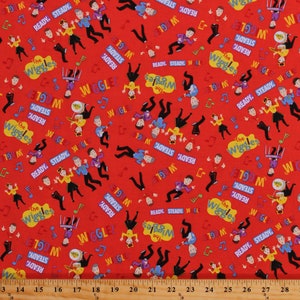 May include: Red fabric with a repeating pattern of the Wiggles characters. The characters are in their signature colors and are performing various actions, such as playing instruments and dancing. The fabric also features the words "The Wiggles", "Ready, Steady, Wiggle!" and musical notes.