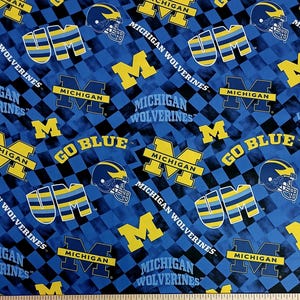 May include: Blue and yellow patterned fabric featuring the University of Michigan Wolverines logo, helmets, and the words "GO BLUE" and "MICHIGAN WOLVERINES". The design is set against a checkered background.