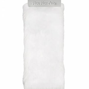 May include: White faux fur fabric, packaged in a clear plastic bag with a silver label that reads "Fun Fur Cuts".