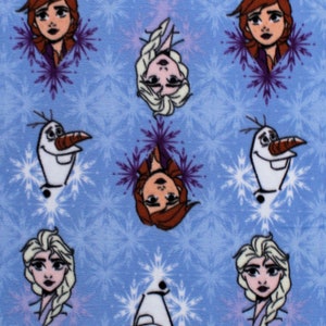 May include: Blue fabric with a repeating pattern of snowflakes, Elsa and Anna from Frozen, and Olaf the snowman.