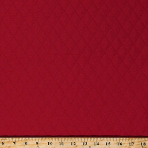 May include: Red fabric with a diamond pattern. The fabric is textured and has a subtle sheen.