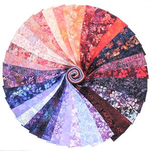 May include: A bundle of 24 fabric strips in shades of purple, blue, and red with floral patterns. The fabric is arranged in a fan shape, with the ends of the strips overlapping.