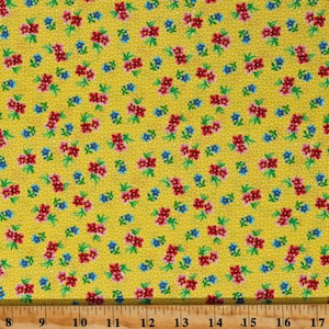 May include: Yellow fabric with a repeating pattern of small pink and blue flowers. The fabric is textured and has a subtle sheen.