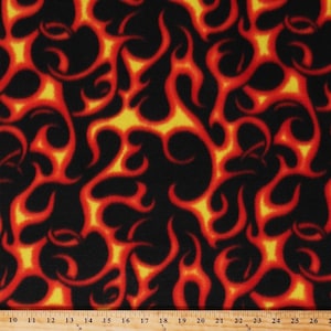 May include: Black fabric with a repeating pattern of orange and yellow flames.