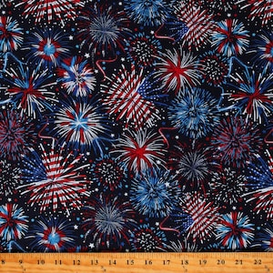 May include: A navy blue fabric with a repeating pattern of red, white, and blue fireworks. The fireworks are stylized and resemble a burst of stars.