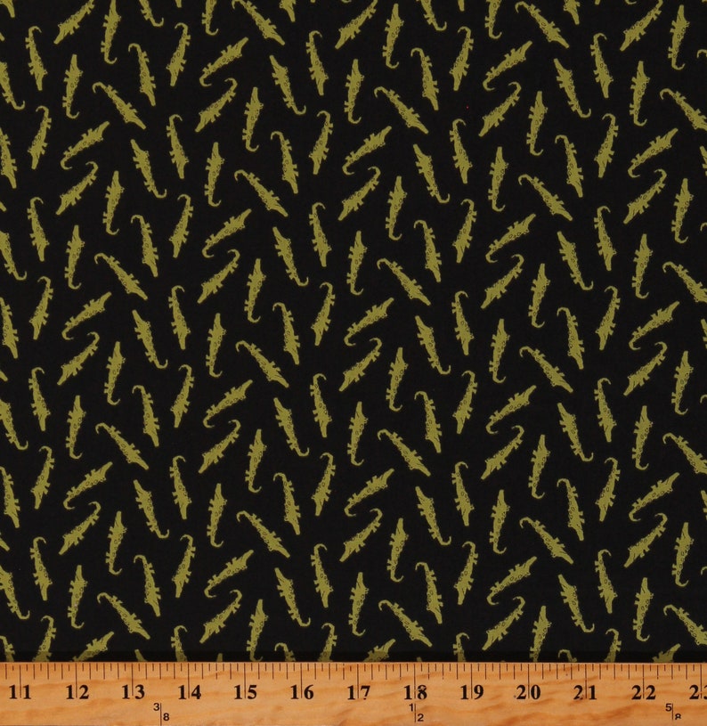 May include: Black fabric with a repeating pattern of gold alligator silhouettes.