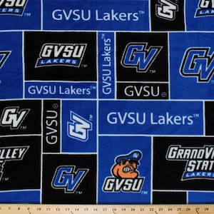 May include: A blue and black fabric with a repeating pattern of the Grand Valley State University Lakers logo. The logo features a bulldog mascot, the school's initials "GVSU", and the words "Grand Valley State Lakers".