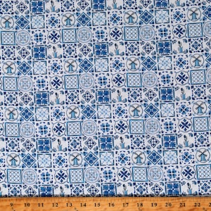 May include: White fabric with a repeating pattern of blue and white tiles. The tiles feature various geometric designs, including windmills, flowers, and squares.
