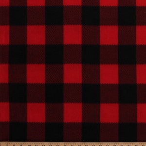 May include: Red and black plaid fabric with a soft, fuzzy texture. The fabric is measured in inches.