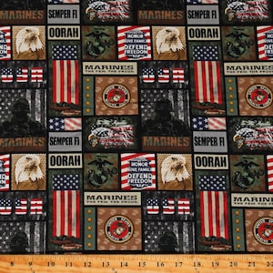 May include: A black fabric with a repeating pattern of American flags, eagles, and the words "Marines", "Semper Fi", and "Oorah". The fabric also features the United States Marine Corps emblem.