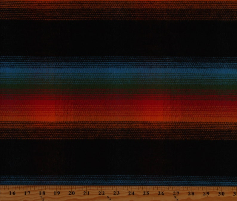 May include: Striped fabric with a black background and horizontal stripes in shades of orange, red, green, and blue. The fabric is measured with a ruler in inches.