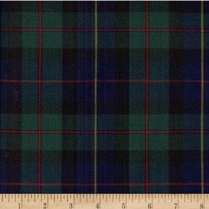 May include: A close-up of a fabric with a classic plaid pattern. The design features a grid of intersecting lines in green, navy blue, red, and yellow. The fabric is likely used for clothing or home decor.
