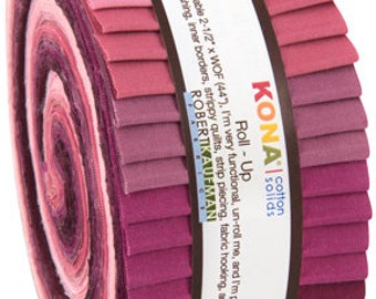 May include: A roll of 2.5 inch wide Kona cotton fabric in shades of pink and purple. The roll is labeled "Kona Cotton Solids Roll-Up".