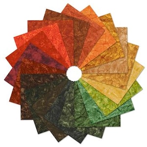 May include: A circular arrangement of textured paper sheets in a variety of colors, including shades of red, orange, yellow, green, and brown. The sheets are arranged in a radial pattern, with a white circular space in the center.