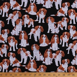 May include: A black fabric with a repeating pattern of brown and white Cavalier King Charles Spaniel dogs. The dogs are in various poses, including sitting, standing, and lying down.
