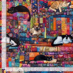 May include: A multi-colored fabric featuring a patchwork pattern of cats in various poses, including a black cat, a Siamese cat, and a tabby cat. A ruler on the left side shows a length of 11 inches, and a ruler at the bottom shows 11 inches.