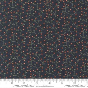 May include: Dark navy fabric with a repeating pattern of red berries and green leaves on winding stems. The fabric has a ruler along the bottom edge with the word "moda" printed on it.