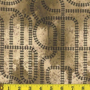 May include: Fabric with a repeating pattern of black railroad tracks on a tan and brown mottled background. The tracks curve and intersect, creating a complex design. The fabric has a vintage or rustic aesthetic.