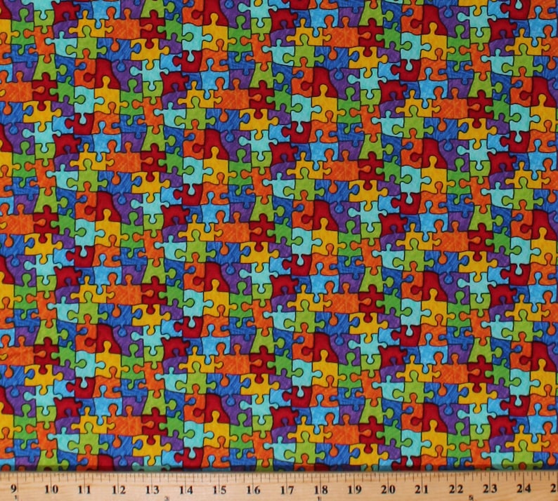 May include: A colorful fabric with a repeating pattern of puzzle pieces in various colors, including red, orange, yellow, green, blue, and purple.