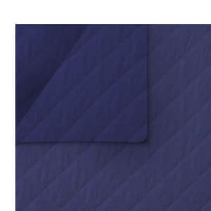 May include: A navy blue quilted blanket with a diamond pattern. The blanket is folded over, showing a corner of the top layer. The fabric has a soft, matte finish, and the overall aesthetic is simple and modern.