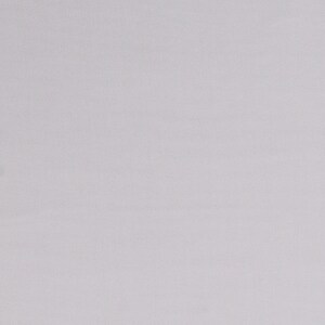 May include: A plain white fabric background with a subtle texture.