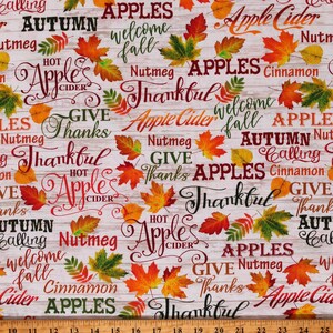 May include: A white background with a woodgrain pattern features a repeating pattern of fall-themed words and images. The words include "Apples", "Autumn Calling", "Welcome Fall", "Hot Apple Cider", "Give Thanks", "Thankful", "Nutmeg", and "Cinnamon". The images include red, orange, and yellow leaves.