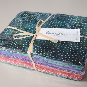 May include: A stack of 10 colorful fabric squares wrapped in plastic with a brown ribbon and a tag that says "Boundless Fabrics by Craftsy".