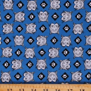 May include: Blue fabric with a repeating pattern of white cat faces and black paw prints. The fabric is a cotton blend and is suitable for quilting, crafts, and apparel.