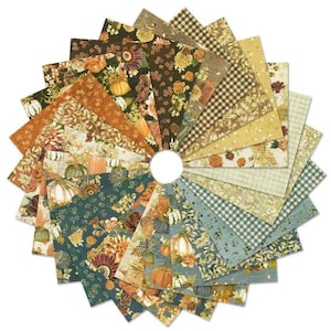 May include: A collection of square fabric swatches arranged in a circular fan pattern. The fabric features various autumn-themed prints including pumpkins, foliage, floral motifs, and geometric patterns in shades of orange, brown, green, and cream.