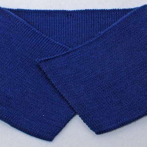May include: A dark blue knitted collar, folded in half, with a smooth texture. The collar is made of a soft, stretchy fabric.