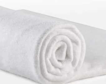 May include: A white, rolled up, soft, plush, and fluffy towel.