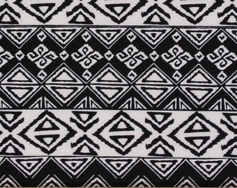 May include: Black and white geometric patterned fabric with a repeating design of triangles and diamonds. The fabric is measured with a ruler in inches.