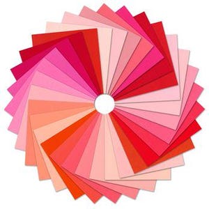 May include: A circular arrangement of square paper sheets in a gradient of colors ranging from pale pink and peach to vibrant orange, bright red, magenta, and deep crimson, all overlapping and radiating from a small white circular center hole.
